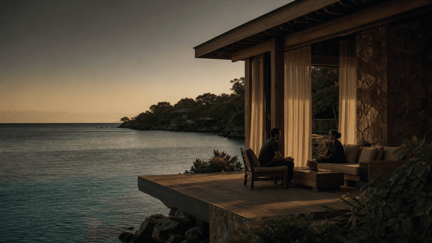 Caribbean modern villa above calm ocean water in Honduras at dusk